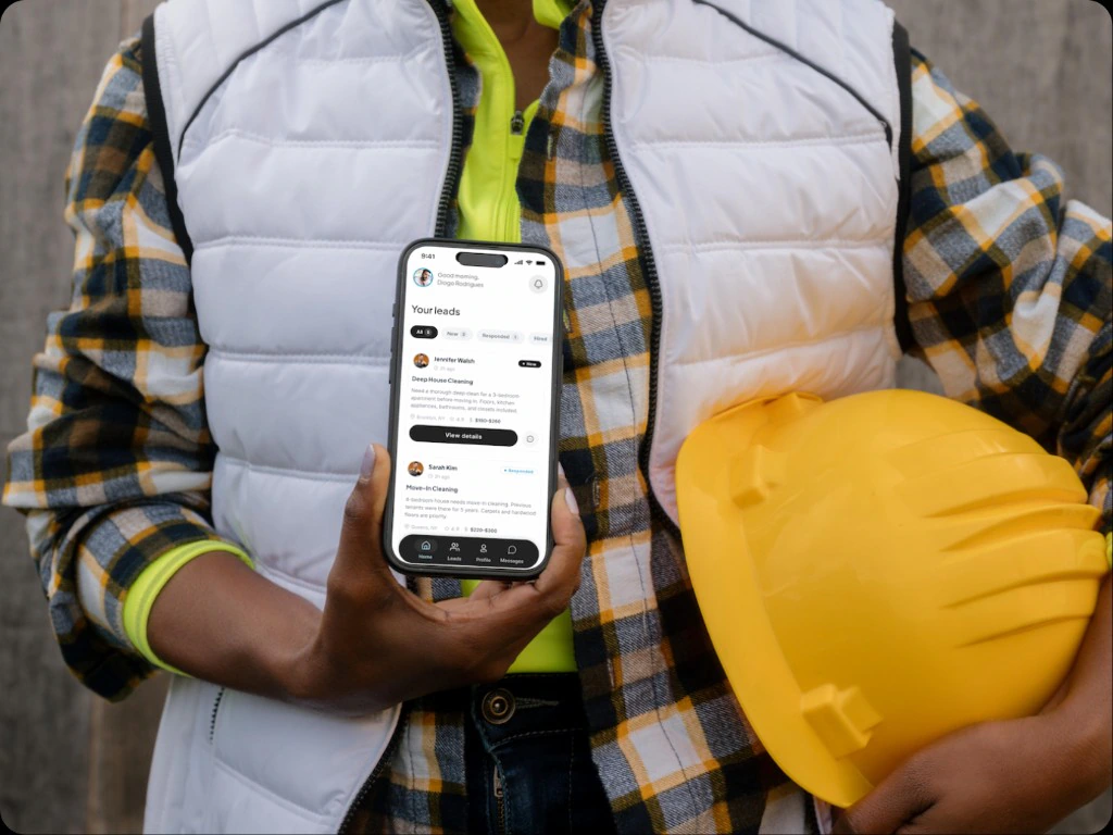 Worker holding phone with leads on screen